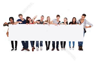 College students displaying blank billboard