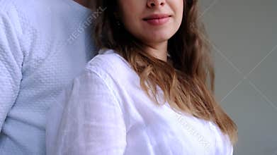 Pregnant woman with a man on a white background. Selective focus.