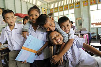 Asian School Group in uniform playing with camera