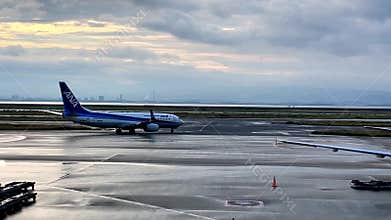 ANA All Nippon Airways Aircraft Taxiing on Wet Runway at Sunset Japan Airport Osaka 20.10.2025 Japan