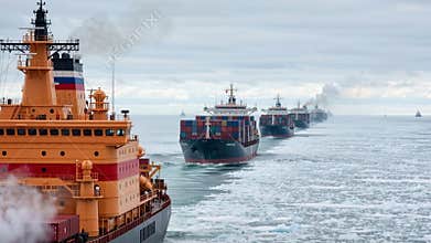 Large orange icebreaker leading a convoy of cargo container ships through a frozen ocean. Commercial vessels navigating an icy