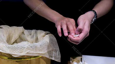 Hands slicing fish the process of making sushi Cook slices green cucumber. Asian chef makes sushi Rice gloves. Silver
