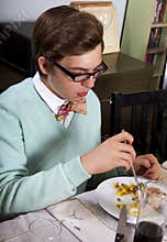 Young man eats Thanksgiving dinner turkey