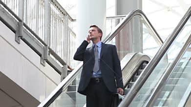 Business man on escalator
