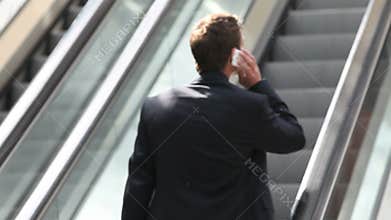 Business man on escalator