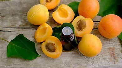 Apricot essential oil in a bottle. Selective focus.