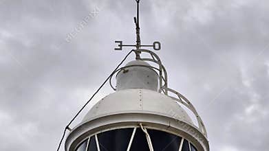 The Lighthouses Beacon Top Surrounded By Beautiful Atmospheric Clouds in the Sky