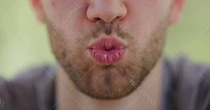 Close-up of a person's lips and beard while
