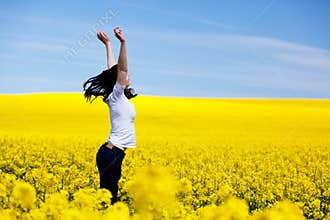 Happy young woman on spring field. Success