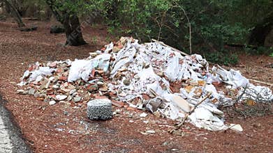 Construction debris and garbage polluting a roadside area