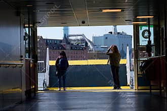 Vasttrafik ferry crossing Gota river in front of the Roselundverket combined heat and power powerplant on May 13, 2025 in