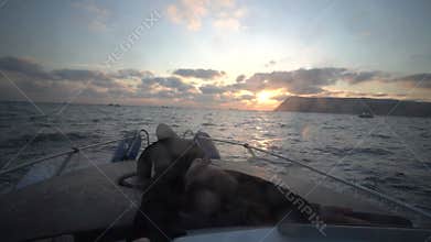 Woman boat sunset, long-haired female enjoying freedom on boat at golden hour.