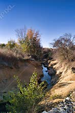 Scenic river flowing through autumn landscape in a serene countryside setting