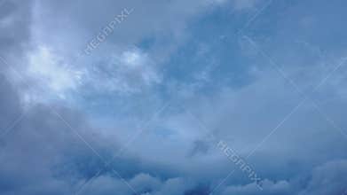 Dramatic timelapse of turbulent clouds in a stormy sky with various shades of blue