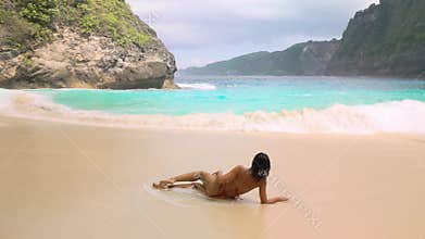 Woman Relaxing By Turquoise Waves At Kelingking Beach Nusa Penida