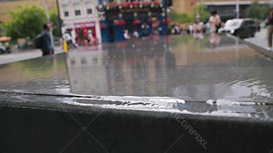 The video shows a lively city transformed by rain, highlighting resilience