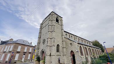 Historic Saint-Pierre Church in Le Crotoy, Somme Bay, France, with its Romanesque-style stone facade, arched windows, and square