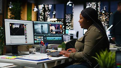 African american female videographer editing a film montage project