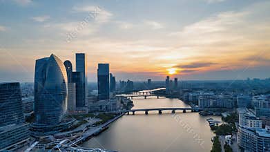Sunset over river city skyline with bridges and towers