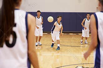 High School Students Playing Dodge Ball In Gym