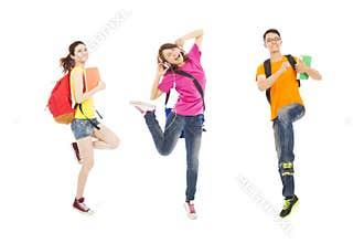 Happy students listening music and jumping with books