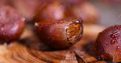 a hard, edible chestnut fruit in a brown shell covered with