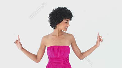 Smiling woman in pink pointing up