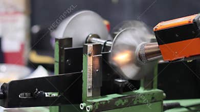 Turbocharger turbine wheel spinning rapidly on a dynamic balancing machine