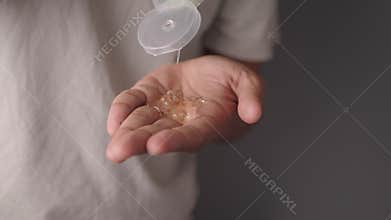 pouring aloe vera gel on hand .