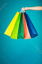 Colorful shopping bags in female hand. Sale retail