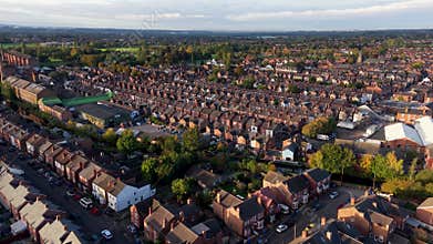 Aerial view above generic terraced houses on a council house estate in UK