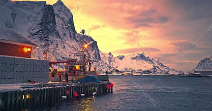 Fishermen, nets, fishing boat on arctic sea harbor, Lofoten Islands, Norway, Europe and arctic fjords sunset landscape