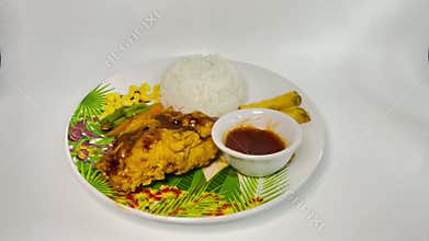 someone dipping French fries into a small bowl of curry sauce.