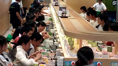 People are sitting around, enjoying a mobile hot pot