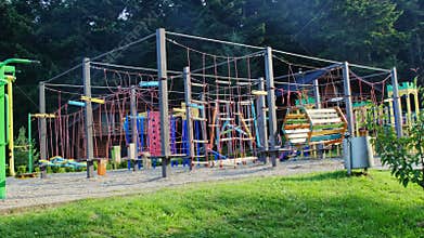 Colorful playground with rope ladder swings and maze in park