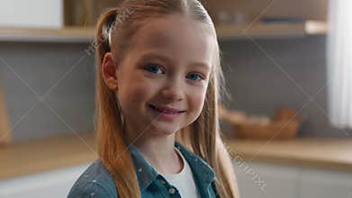 Close up schoolgirl Caucasian child girl daughter kid satisfied toothy smiling looking at camera portrait at home