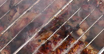 marinated pork meat with spices during cooking on the grill
