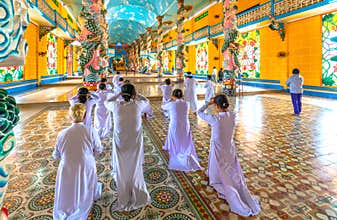 People praying in holy Cao Dai monastery