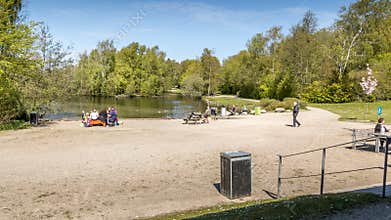 The Doctor Park in Randers. people sit and drink coffee in nature. picnic in the park. lake and forest in the background