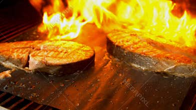 Salmon fish cuts being grilled with fire
