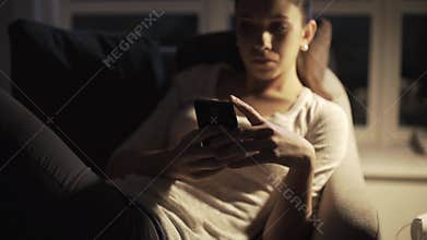Sad girl chatting with friends late at night
