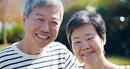 Elderly couple smile at you