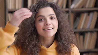 Smiling hispanic teen girl school student looking at camera, close up portrait.