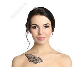 Young woman with tattoo of butterfly on her body against white background