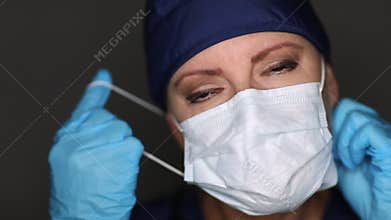Female Doctor or Nurse Wearing Medical Face Mask Then Taking It Off of Her Face