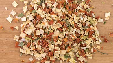dried soup vegetables creating heap on wooden board. motion animation. Spices and food ingredients