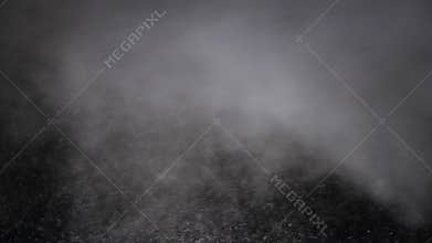 Footage of snow and steam flying all over the place on a black background. Snowstorm in an abstract shot. Constantly