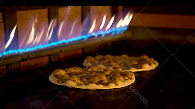 Close up of Lebanese Arabian pizza cooking in the oven and the cheese melting