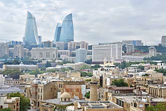 Baku, Azerbaijan, September, 10, 2019. Old town of Icheri Sheher and high-rise buildings `Flame towers` on the horizon. Azerbaijan
