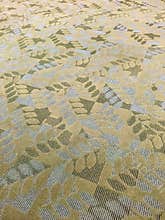 Contemporary textured gold, white and green  carpeting.
